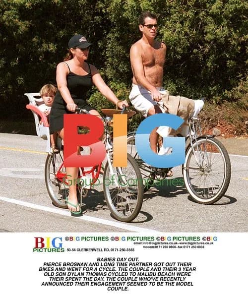 Pierce Brosnan Cycles with Partner and Son