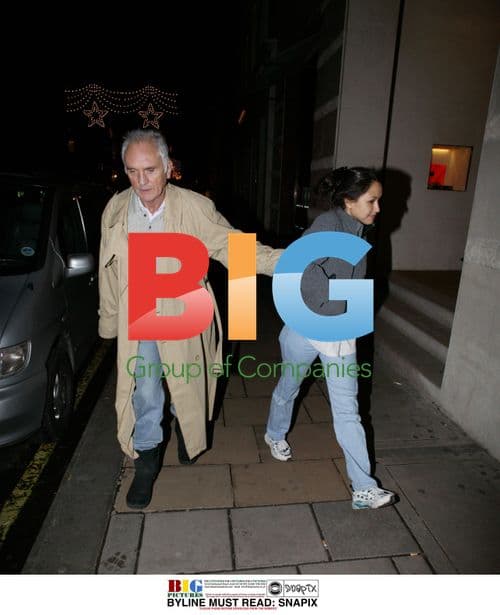 Terence Stamp and mystery lady out in London