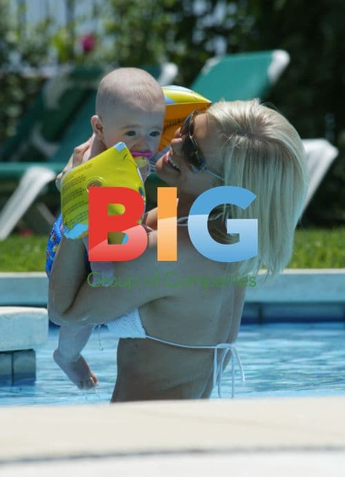 Singer Suzanne Shaw plays with child in pool