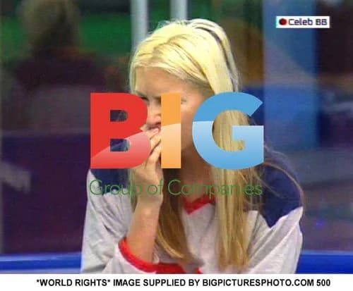 Caprice Covers Lips for Private Talk