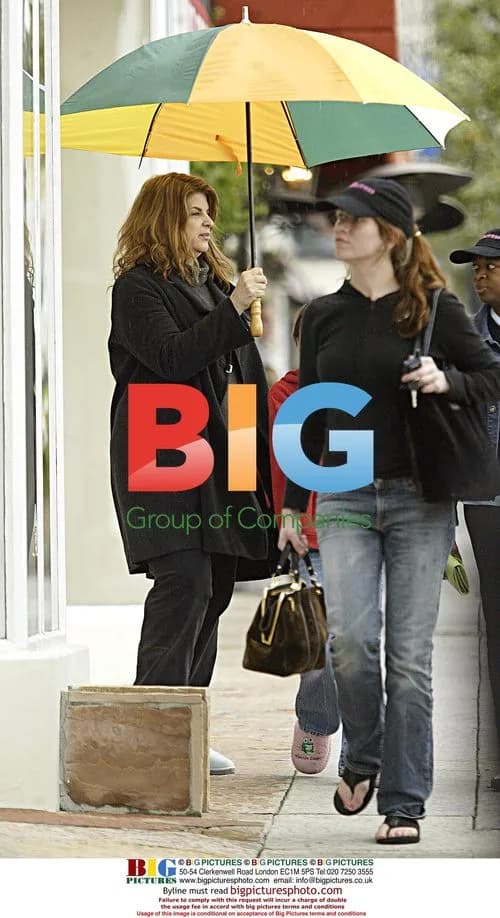Kirstie Alley Stays Dry Shopping with Kids