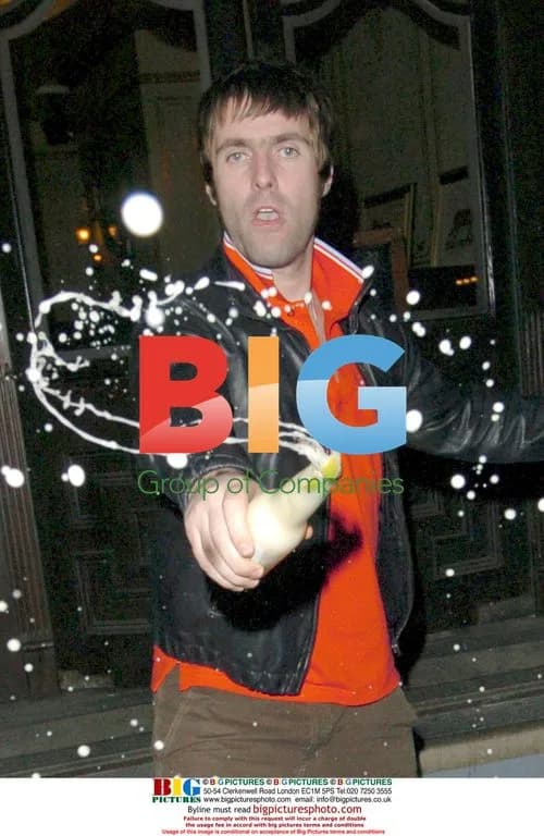 Liam Gallagher has a beer handshake with paparazzi