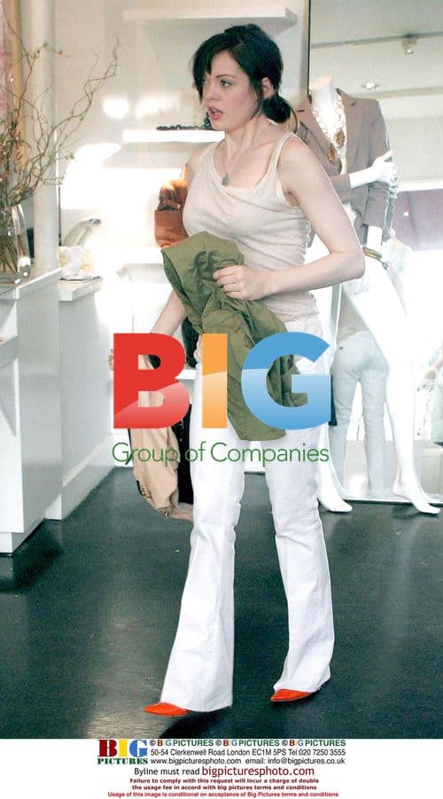 Rose McGowan Juggles Clothing While Shopping in Beverly Hills