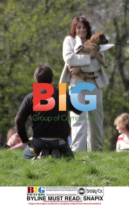 Sarah Parish and Boyfriend Canoodling in Park