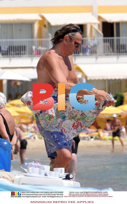 Jerry Hall with mystery boyfriend on beach