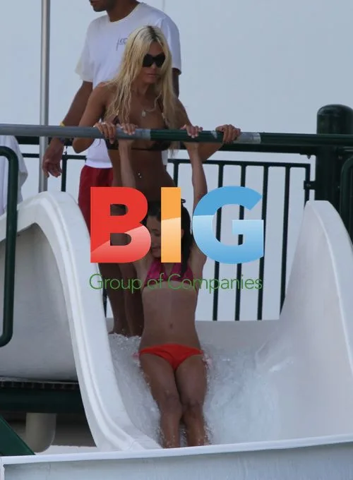 Shauna Sand Relaxes Poolside with Daughters
