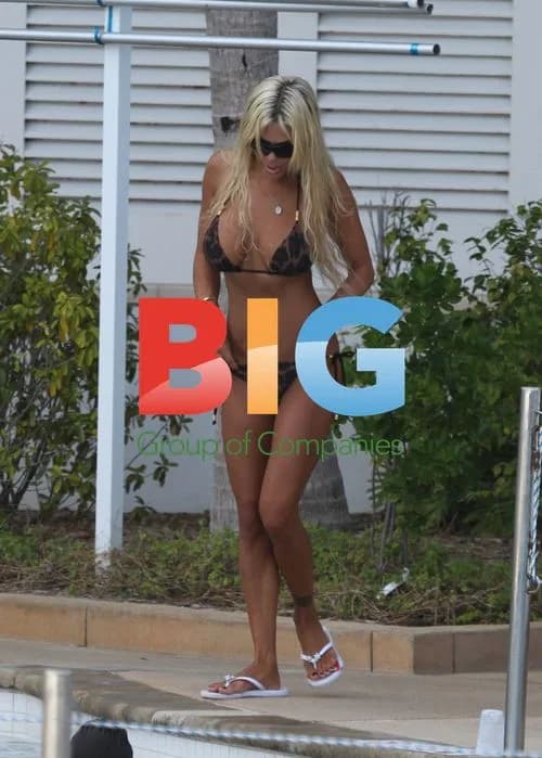 Shauna Sand Relaxes Poolside with Daughters