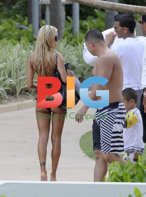 Shauna Sand relaxes poolside with daughters
