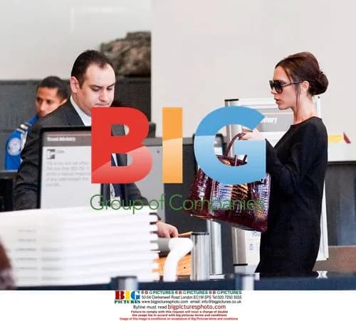 Victoria Beckham departs LAX in black mini-dress