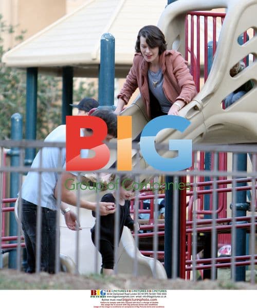 Milla Jovovich and family playing at park