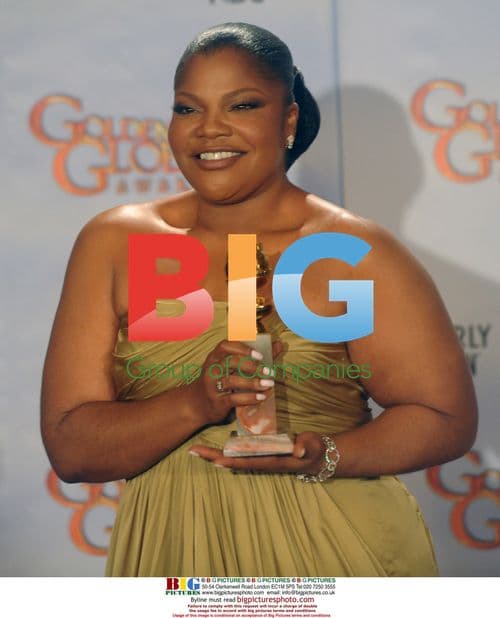 Monique Holds Golden Globe Award