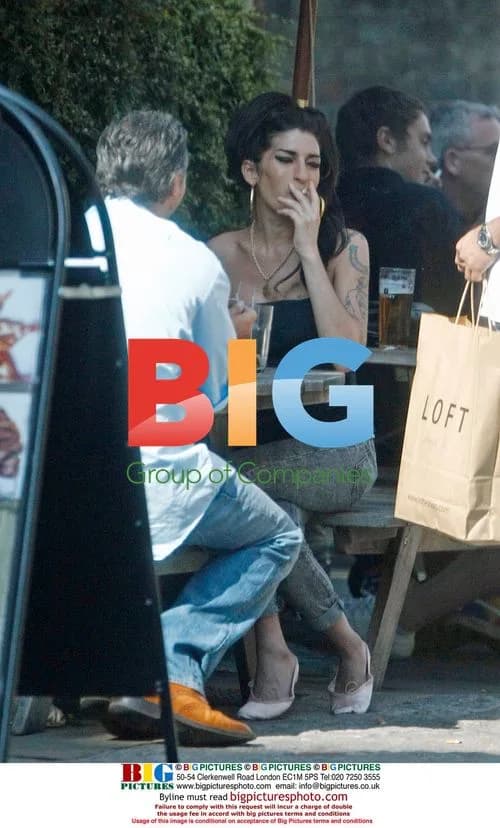 Amy Winehouse Interacts with Child at Pub