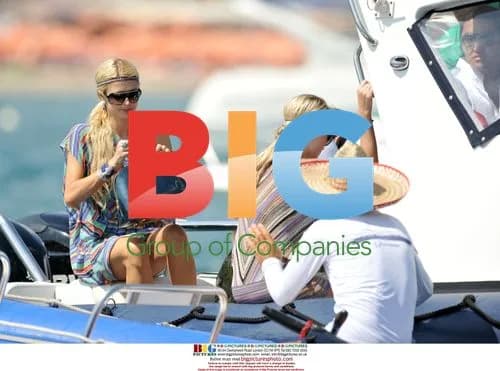 Paris and Nicky Hilton Arrive at Beach by Boat