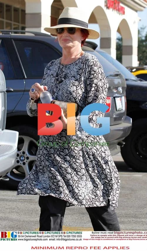 Ozzy Osbourne Leaving Drugstore with Wife