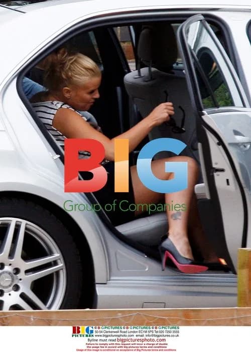 Kerry Katona waves to kids leaving home