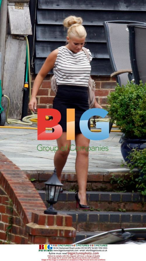 Kerry Katona waves to kids leaving home