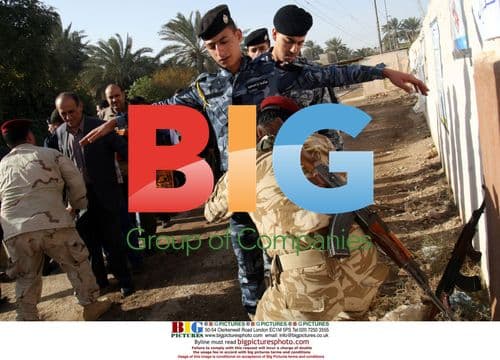 Iraqi Policemen Frisked Before Voting