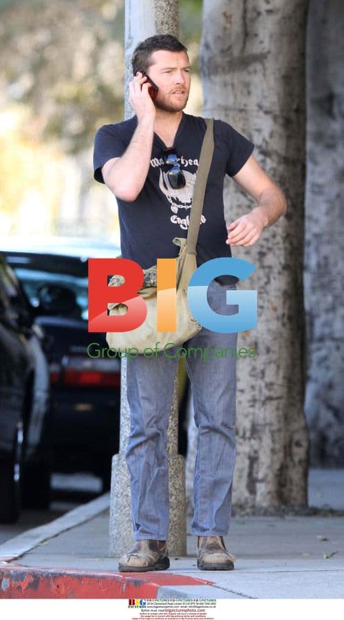 Sam Worthington on the phone in Beverly Hills