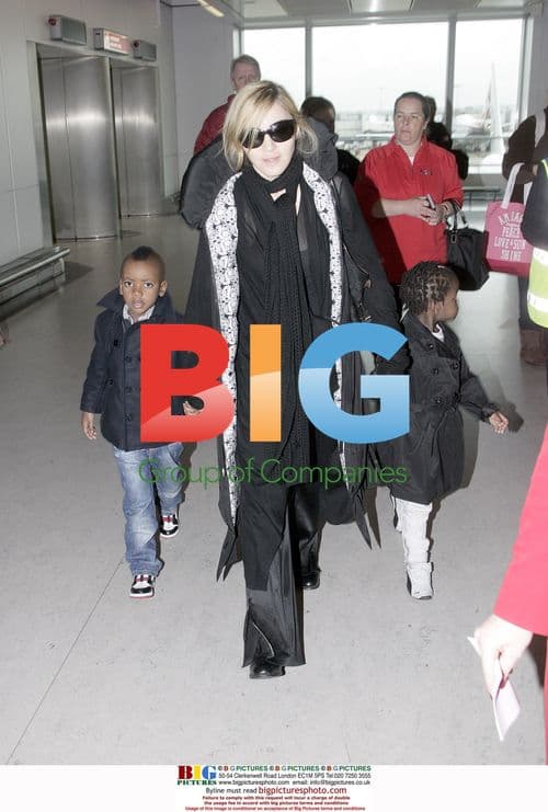 Madonna arrives with David and Mercy at Heathrow