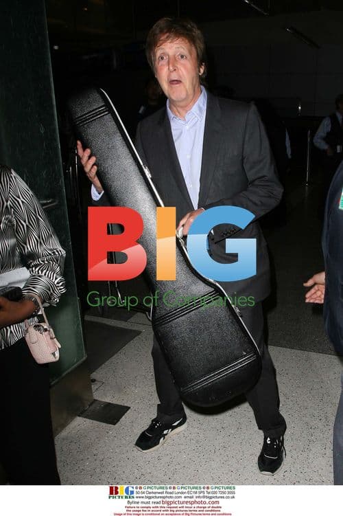 Paul McCartney Arrives at LAX with Guitar