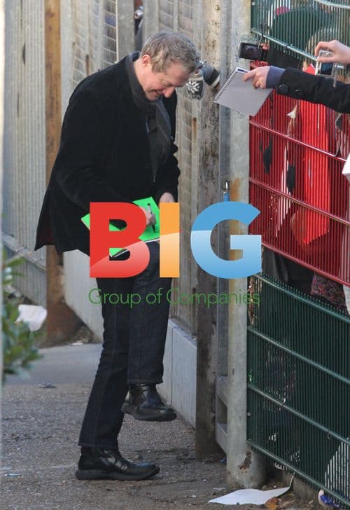 Louis Walsh signs autographs