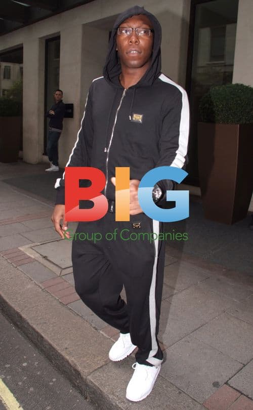 Dizzy Rascal carrying award in London