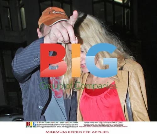 Liam Neeson Walking with Blonde Woman