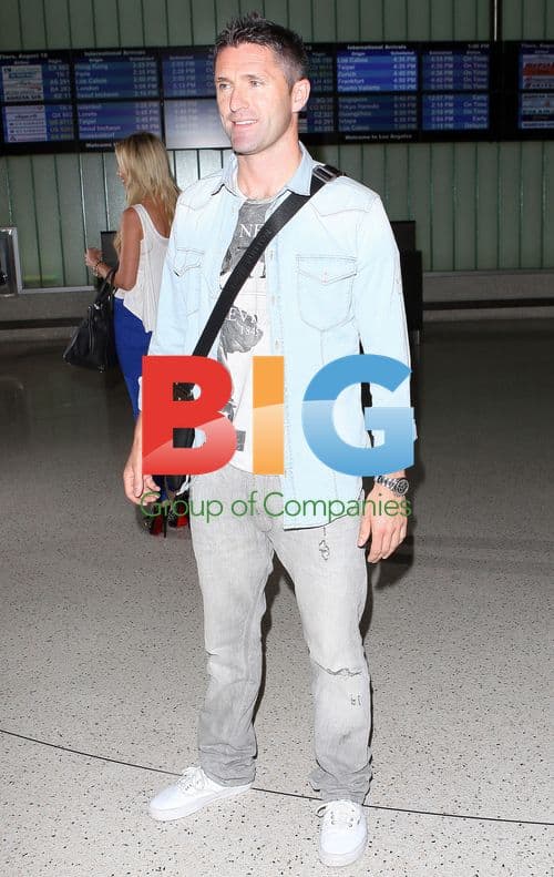 Robbie Keane and wife Claudine arrive at LAX