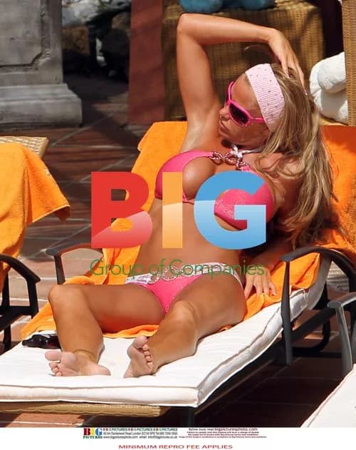 Katie Price relaxes poolside in Spain