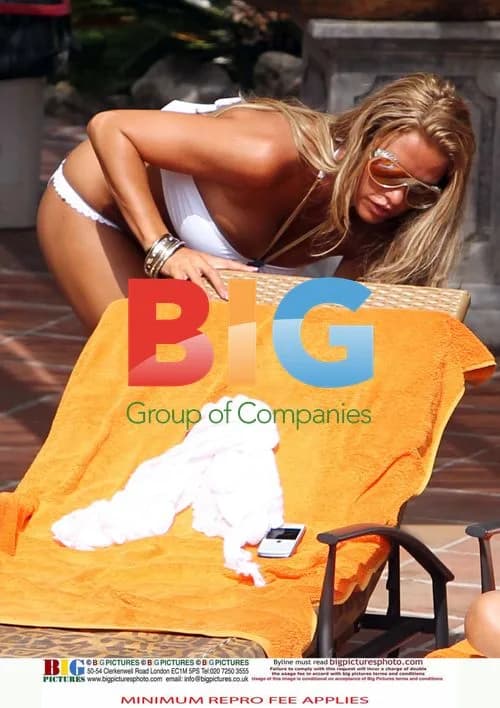 Katie Price relaxes poolside in Spain
