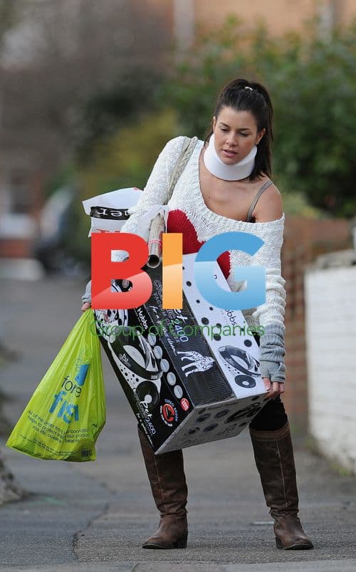 Imogen Thomas Struggles with Neck Brace in London