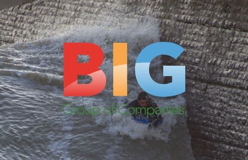 Surfer Edges Brick Wall in Stormy Weather