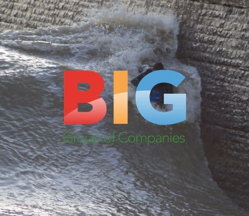 Surfer Edges Brick Wall in Stormy Seas