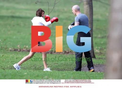 Liz Locke exercises with trainer in London park