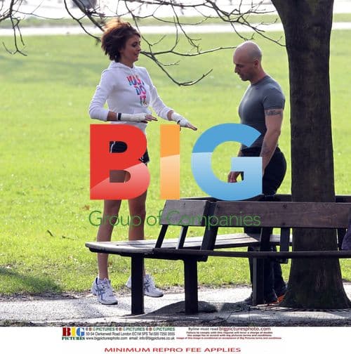 Liz Locke and personal trainer exercise in London park