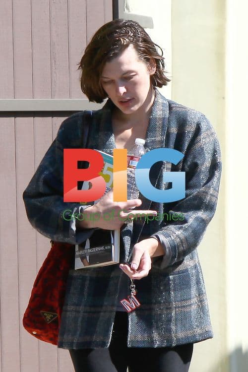 Milla Jovovich Leaves Gym Carrying Diet Books