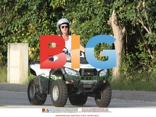Simon Cowell and Mezhgan Hussainy on Quad Bikes
