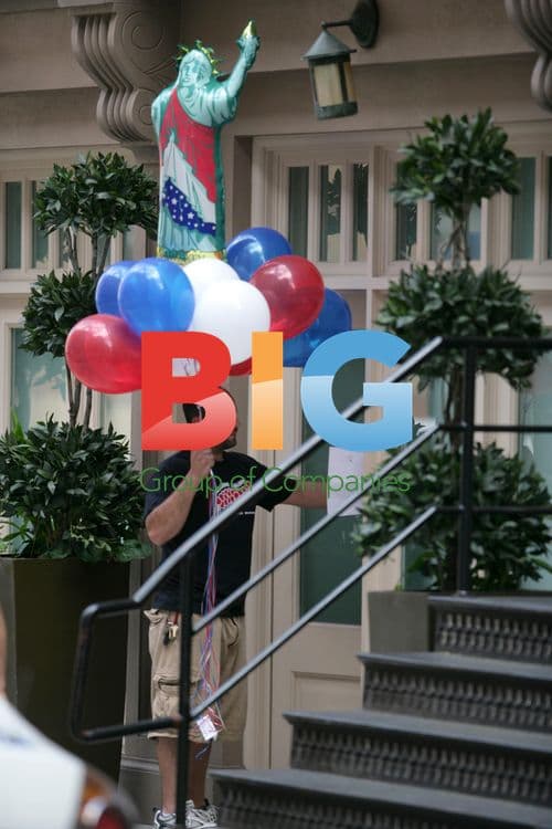 Dominique Strauss-Kahn with Statue of Liberty Balloons