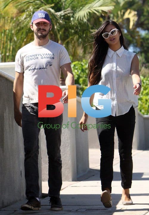 Shia LaBeouf walks with girlfriend Karolyn Pho