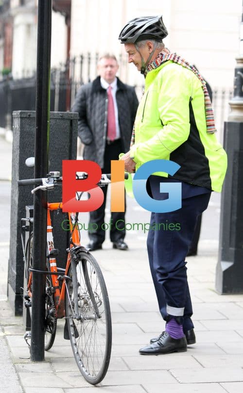 TV Presenter John Snow Riding Bike in London