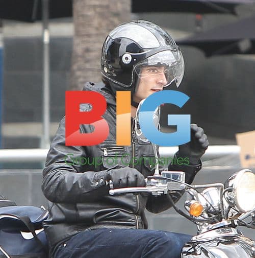 Paul W.S. Anderson Rides Scooter in Rain