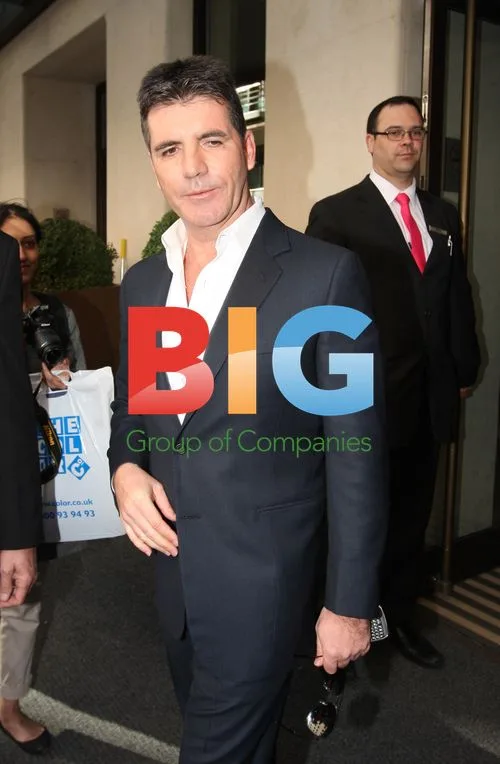 Simon Cowell gets hug outside London hotel