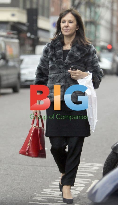 Arlene Phillips waits for car outside London hotel