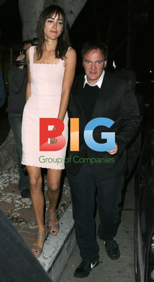 Quentin Tarantino escorting woman from restaurant