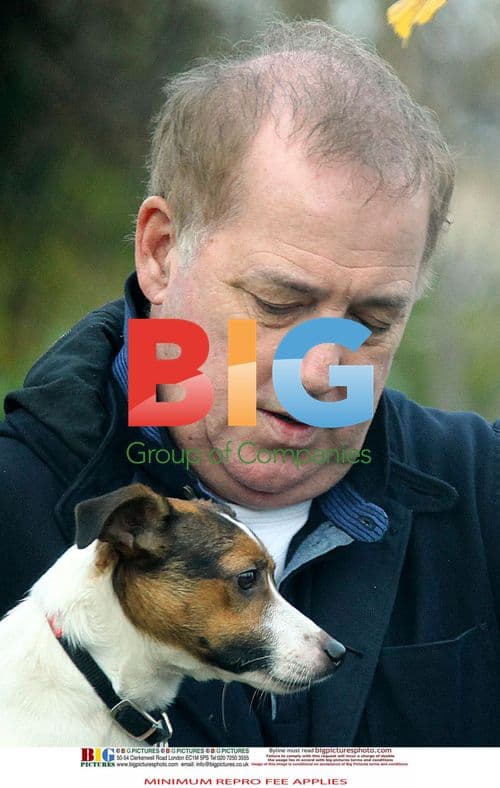 Tired Michael Barrymore walks dog in London