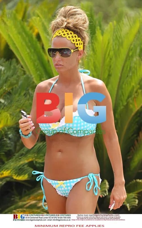 Katie Price relaxes poolside in Spain