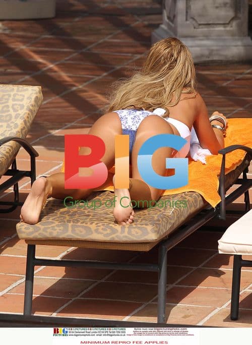 Katie Price Relaxes Poolside in Spain