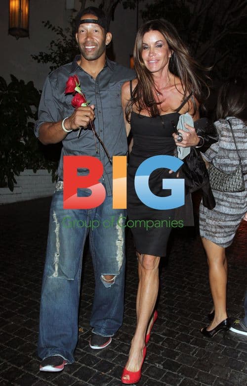 Janice Dickinson shares kiss with companion