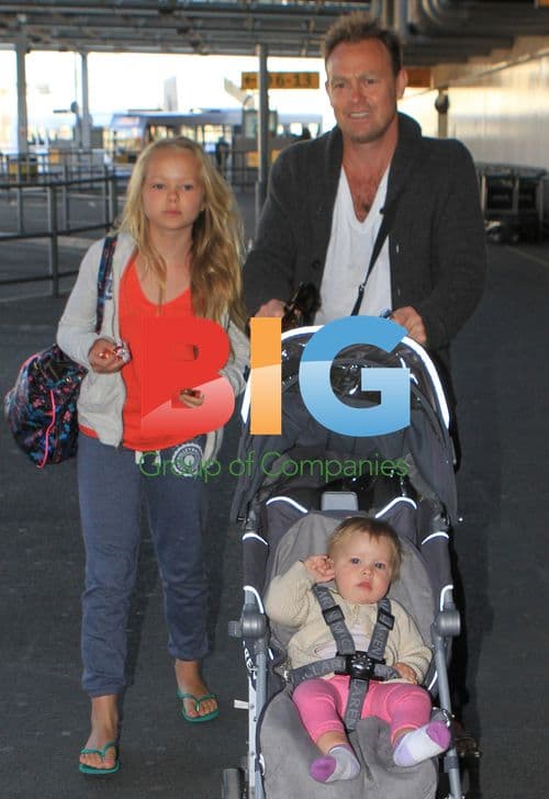 Jason Donovan Arrives at Heathrow with Kids