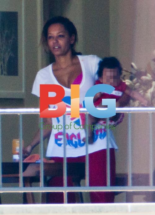 Melanie Brown with family on balcony
